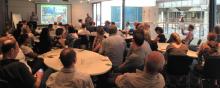 People sitting around tables at the launch of CRN Sydney